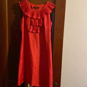 Bright orange sleeveless dress.